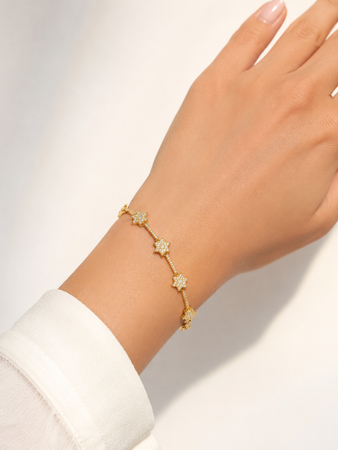 Gold-Tone Brass Star Charm Bracelet with Crystal Accents